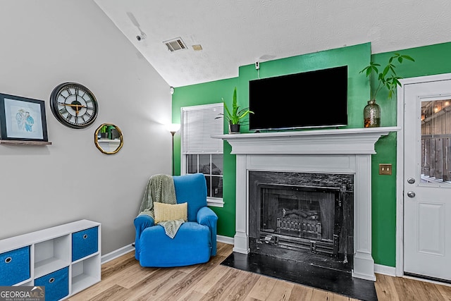 161 Mills Dr, Covington, GA 30016 - living room featuring a premium fireplace, wood finished floors, a textured ceiling, and baseboards