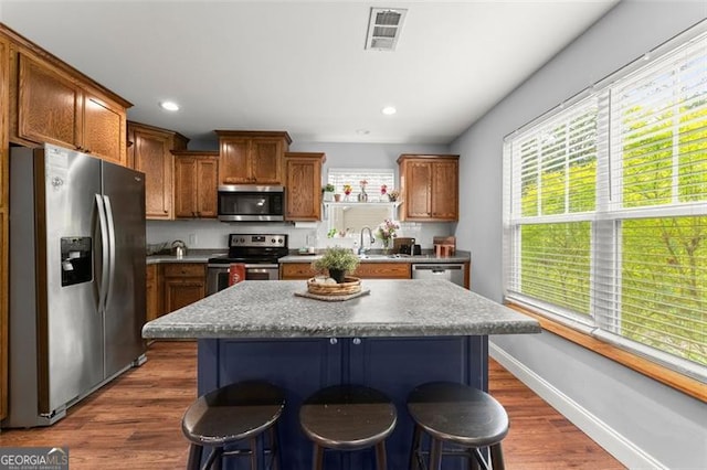 15 Baker St, Dahlonega, GA 30533 - kitchen featuring appliances with stainless steel finishes, a breakfast bar, a center island, dark wood finished floors, and recessed lighting
