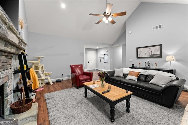 15 Baker St, Dahlonega, GA 30533 - living area with a stone fireplace, wood finished floors, high vaulted ceiling, ceiling fan, and recessed lighting