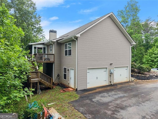15 Baker St, Dahlonega, GA 30533 - view of home's exterior with a chimney, stairs, driveway, a deck, and an attached garage