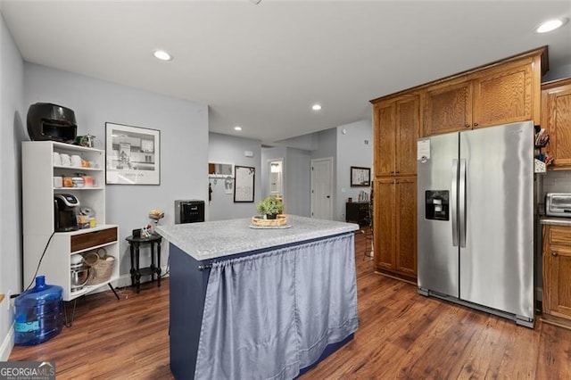 15 Baker St, Dahlonega, GA 30533 - kitchen featuring stainless steel fridge, dark wood-style flooring, brown cabinetry, a center island, and light countertops