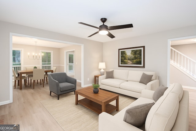 4806 Deer Chase, Powder Springs, GA 30127 - living room featuring light wood-style flooring, a chandelier, ceiling fan, and stairs