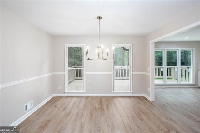 4806 Deer Chase, Powder Springs, GA 30127 - unfurnished dining area with a chandelier, wood finished floors, and baseboards