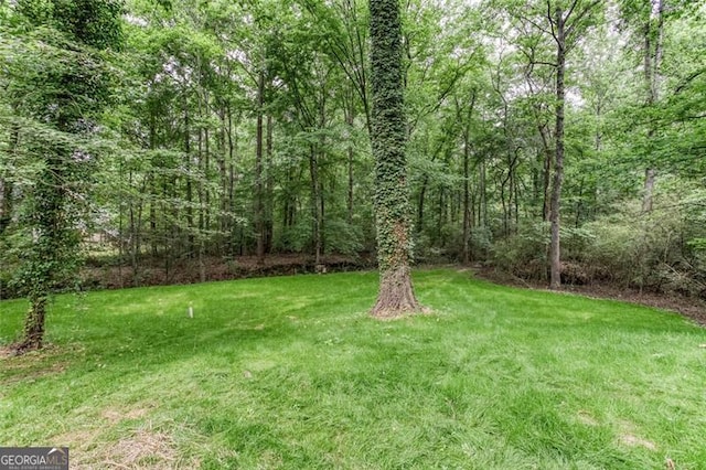 4806 Deer Chase, Powder Springs, GA 30127 - view of grassy yard with a forest view