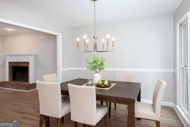 4806 Deer Chase, Powder Springs, GA 30127 - dining space featuring a chandelier, wood finished floors, a brick fireplace, and baseboards