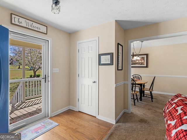 115 Christie Ln, Mcdonough, GA 30252 - foyer entrance featuring a chandelier, baseboards, and a textured ceiling