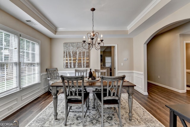 2633 Hanriva Ct, Dacula, GA 30019 - dining area featuring ornamental molding, arched walkways, wood finished floors, a chandelier, and a tray ceiling