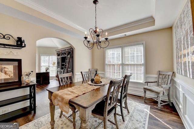 2633 Hanriva Ct, Dacula, GA 30019 - dining area featuring arched walkways, crown molding, a chandelier, wainscoting, and dark wood finished floors