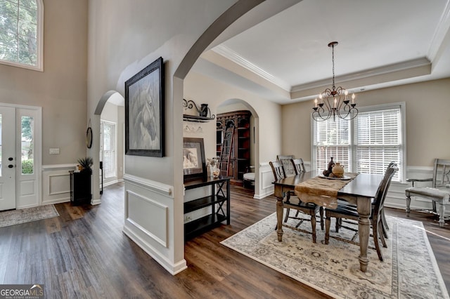 2633 Hanriva Ct, Dacula, GA 30019 - dining area with a raised ceiling, arched walkways, crown molding, a chandelier, and plenty of natural light