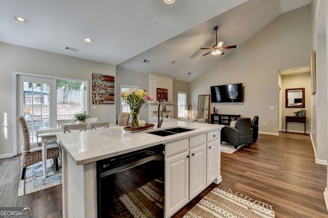 2633 Hanriva Ct, Dacula, GA 30019 - kitchen with black dishwasher, a sink, open floor plan, white cabinetry, and dark wood finished floors