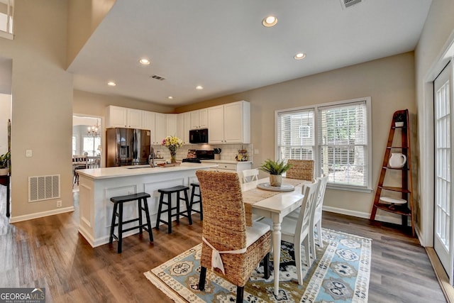 2633 Hanriva Ct, Dacula, GA 30019 - dining area featuring baseboards, recessed lighting, dark wood finished floors, and a chandelier