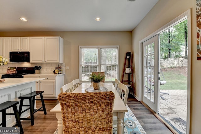2633 Hanriva Ct, Dacula, GA 30019 - dining room featuring healthy amount of natural light, dark wood finished floors, and recessed lighting