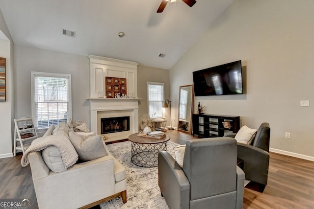 2633 Hanriva Ct, Dacula, GA 30019 - living room with ceiling fan, wood finished floors, a fireplace, healthy amount of natural light, and high vaulted ceiling