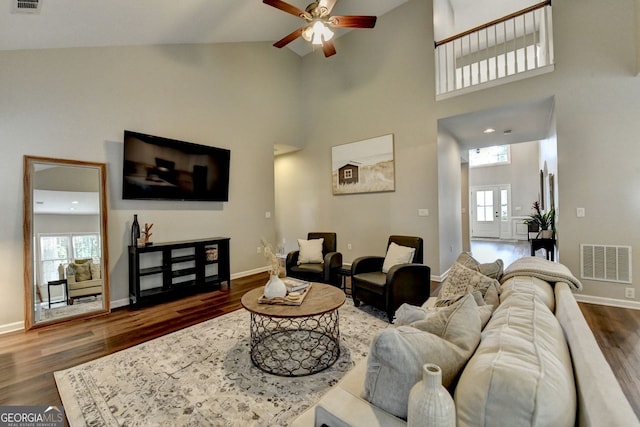 2633 Hanriva Ct, Dacula, GA 30019 - living room featuring a ceiling fan, healthy amount of natural light, dark wood-type flooring, baseboards, and high vaulted ceiling