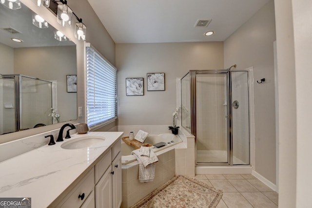 2633 Hanriva Ct, Dacula, GA 30019 - full bathroom featuring vanity, a bath, tile patterned floors, and a shower stall
