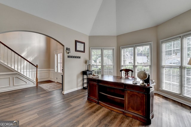 2633 Hanriva Ct, Dacula, GA 30019 - home office with dark wood-type flooring, arched walkways, high vaulted ceiling, and wainscoting