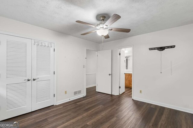 2644 Hickory Valley Dr, Snellville, GA 30078 - unfurnished bedroom featuring wood finished floors, a closet, a textured ceiling, ensuite bathroom, and a ceiling fan