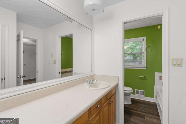 2644 Hickory Valley Dr, Snellville, GA 30078 - bathroom with vanity, a bathtub, and wood finished floors