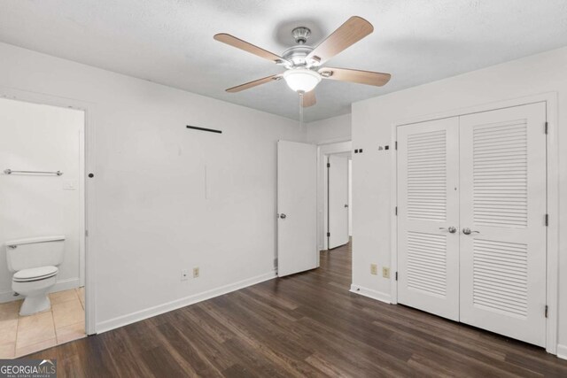 2644 Hickory Valley Dr, Snellville, GA 30078 - unfurnished bedroom featuring wood finished floors, ensuite bath, a closet, and ceiling fan