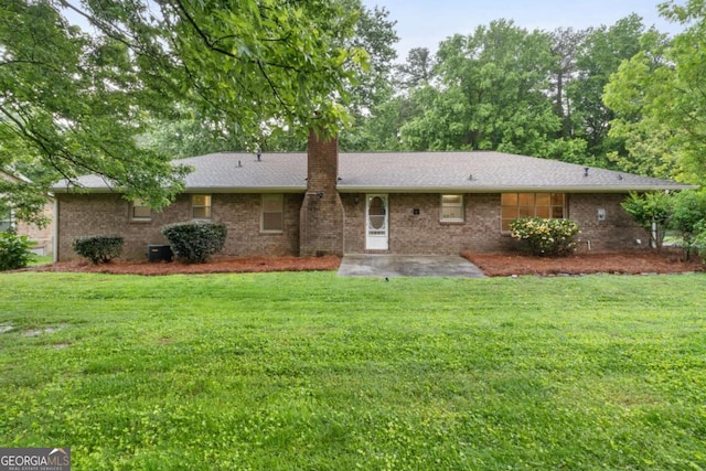 2644 Hickory Valley Dr, Snellville, GA 30078 - rear view of house with a patio area, a chimney, a lawn, and brick siding
