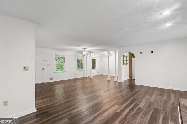 2644 Hickory Valley Dr, Snellville, GA 30078 - unfurnished living room featuring arched walkways, ceiling fan, dark wood finished floors, and a textured ceiling