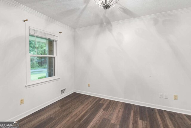 2644 Hickory Valley Dr, Snellville, GA 30078 - spare room featuring dark wood-type flooring, ornamental molding, and a textured ceiling