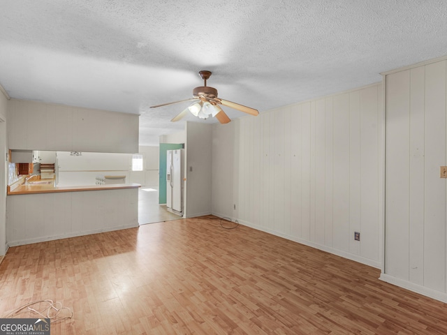 1727 Briarcliff Rd, Milledgeville, GA 31061 - unfurnished living room featuring wood finished floors, a textured ceiling, and ceiling fan