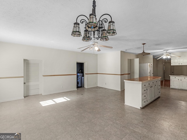 1727 Briarcliff Rd, Milledgeville, GA 31061 - unfurnished living room featuring ceiling fan, a chandelier, a textured ceiling, and tile patterned floors