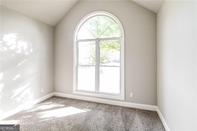 4820 Camden Dr SW, Conyers, GA 30094 - spare room featuring carpet flooring, lofted ceiling, and baseboards