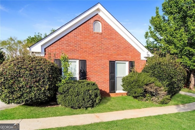 4820 Camden Dr SW, Conyers, GA 30094 - view of property exterior featuring brick siding and a lawn
