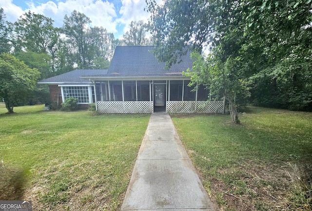 459 Stilson Rd, Brooklet, GA 30415 - view of front of home featuring a sunroom, a shingled roof, and a front lawn