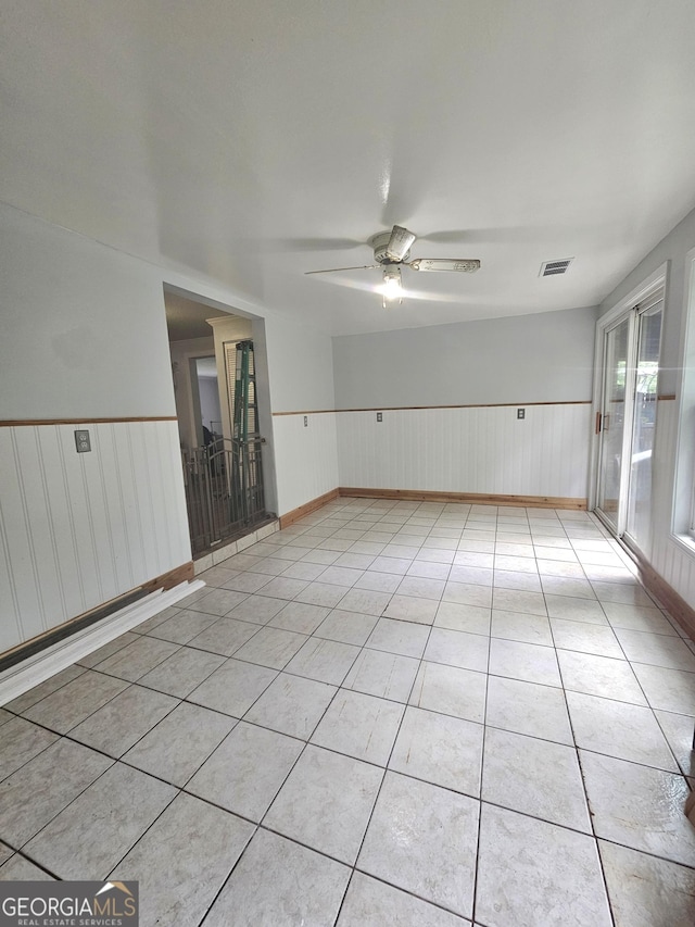 459 Stilson Rd, Brooklet, GA 30415 - unfurnished room with a wainscoted wall, ceiling fan, and light tile patterned floors