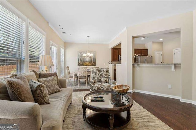 6160 Shiloh Woods Dr, Cumming, GA 30040 - living room featuring a chandelier, dark wood-type flooring, baseboards, crown molding, and recessed lighting