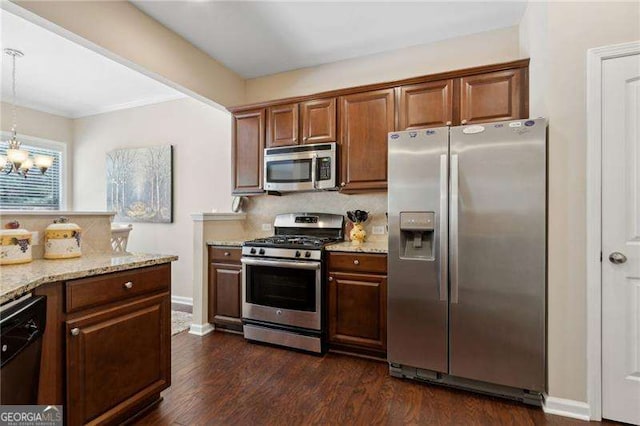 6160 Shiloh Woods Dr, Cumming, GA 30040 - kitchen featuring appliances with stainless steel finishes, tasteful backsplash, dark wood-style floors, and light stone countertops