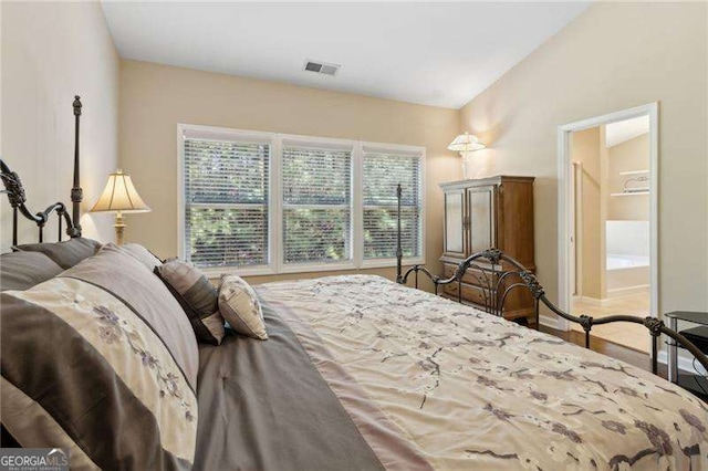 6160 Shiloh Woods Dr, Cumming, GA 30040 - bedroom with connected bathroom, lofted ceiling, and wood finished floors