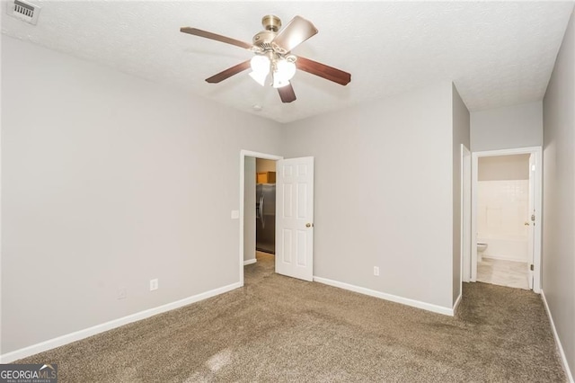 6073 Camden Forrest Dr, Riverdale, GA 30296 - unfurnished bedroom featuring stainless steel fridge with ice dispenser, carpet floors, a ceiling fan, and a textured ceiling
