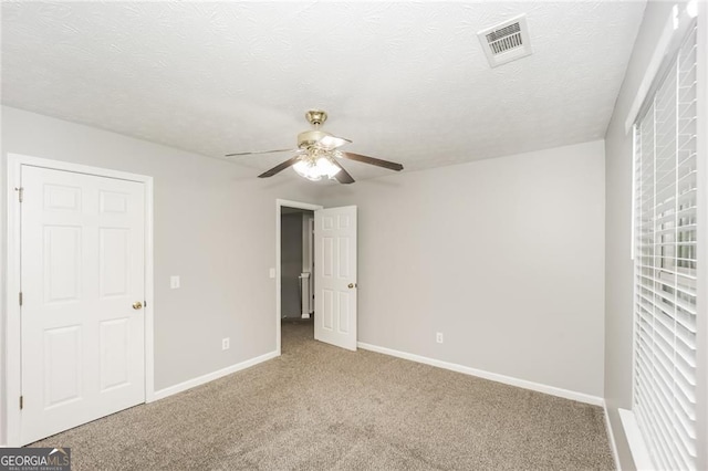 6073 Camden Forrest Dr, Riverdale, GA 30296 - unfurnished bedroom with carpet flooring, a textured ceiling, and a ceiling fan