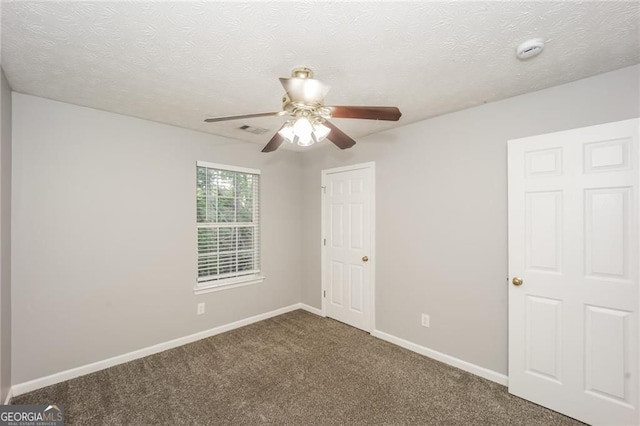 6073 Camden Forrest Dr, Riverdale, GA 30296 - unfurnished bedroom featuring carpet, a textured ceiling, and ceiling fan