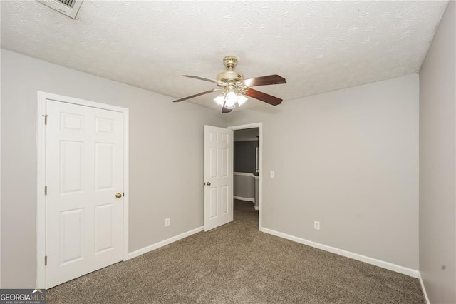 6073 Camden Forrest Dr, Riverdale, GA 30296 - unfurnished bedroom featuring carpet flooring, baseboards, a textured ceiling, and a ceiling fan