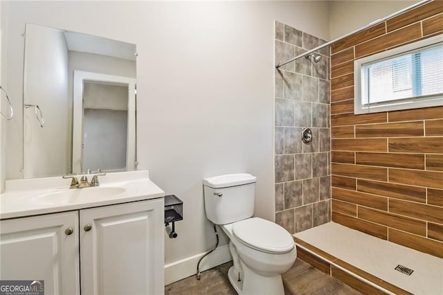 4309 Gilbert Pl, Forest Park, GA 30297 - full bathroom with vanity, toilet, tiled shower, and baseboards