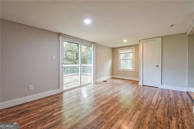 4309 Gilbert Pl, Forest Park, GA 30297 - unfurnished bedroom featuring access to outside, wood finished floors, baseboards, and recessed lighting