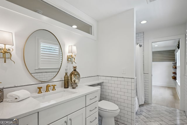1168 Mclynn Ave NE, Atlanta, GA 30306 - full bath featuring vanity, tile walls, recessed lighting, curtained shower, and a wainscoted wall