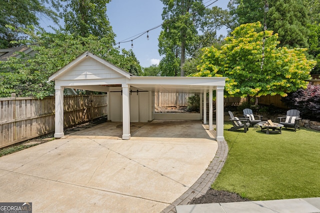 1168 Mclynn Ave NE, Atlanta, GA 30306 - view of patio / terrace featuring an outdoor fire pit, concrete driveway, and a detached carport