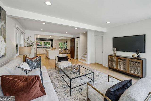 1168 Mclynn Ave NE, Atlanta, GA 30306 - living area with a barn door, recessed lighting, light wood-type flooring, stairs, and baseboards