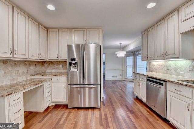 5507 Martina Way, Dunwoody, GA 30338 - kitchen with appliances with stainless steel finishes, light wood-style flooring, backsplash, light stone counters, and recessed lighting
