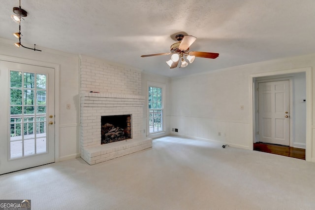 5507 Martina Way, Dunwoody, GA 30338 - unfurnished living room with a ceiling fan, carpet flooring, a brick fireplace, and wainscoting