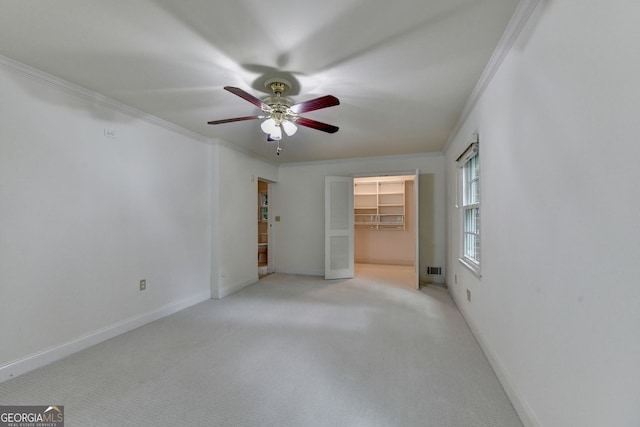 5507 Martina Way, Dunwoody, GA 30338 - unfurnished bedroom with crown molding, carpet, a spacious closet, a ceiling fan, and a closet
