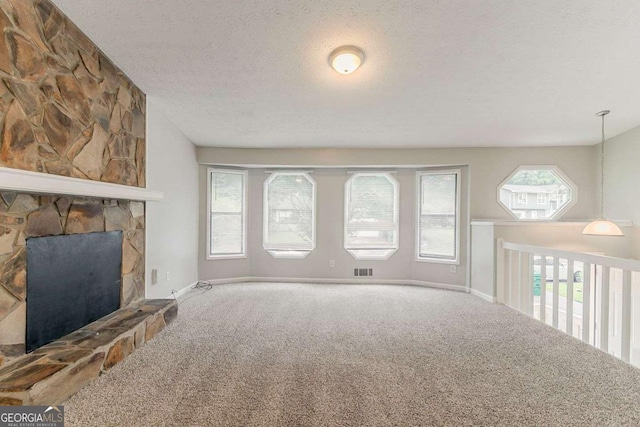 2218 Lowtrail Ct, Lithonia, GA 30058 - unfurnished living room featuring carpet floors, a textured ceiling, baseboards, and a fireplace