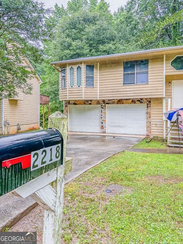 2218 Lowtrail Ct, Lithonia, GA 30058 - bi-level home with a garage and driveway