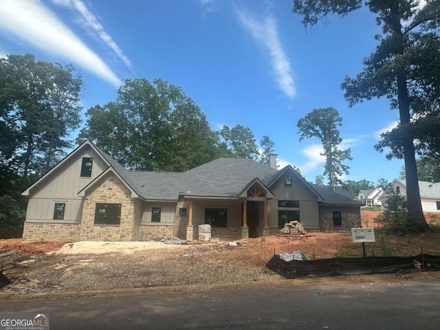 1652 Red Cedar Rd, Commerce, GA 30530 - view of front facade featuring stone siding, board and batten siding, a chimney, and roof with shingles